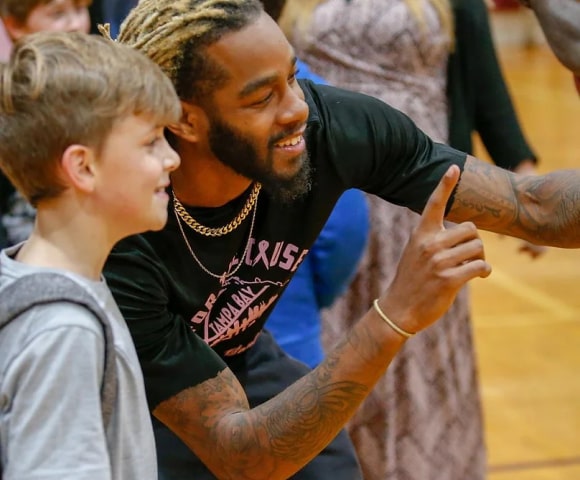 Tampa bay titan player taking a picture with a fan